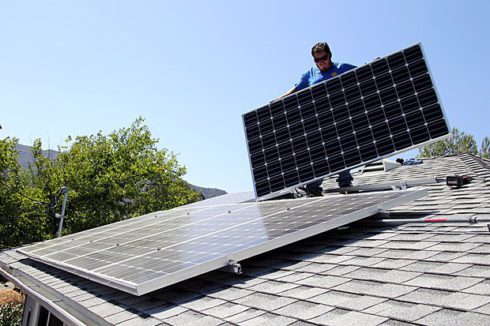 Работник Miracle Solar устанавливает солнечные батареи на доме, штат Калифорния, США, 5 августа 2016 года.